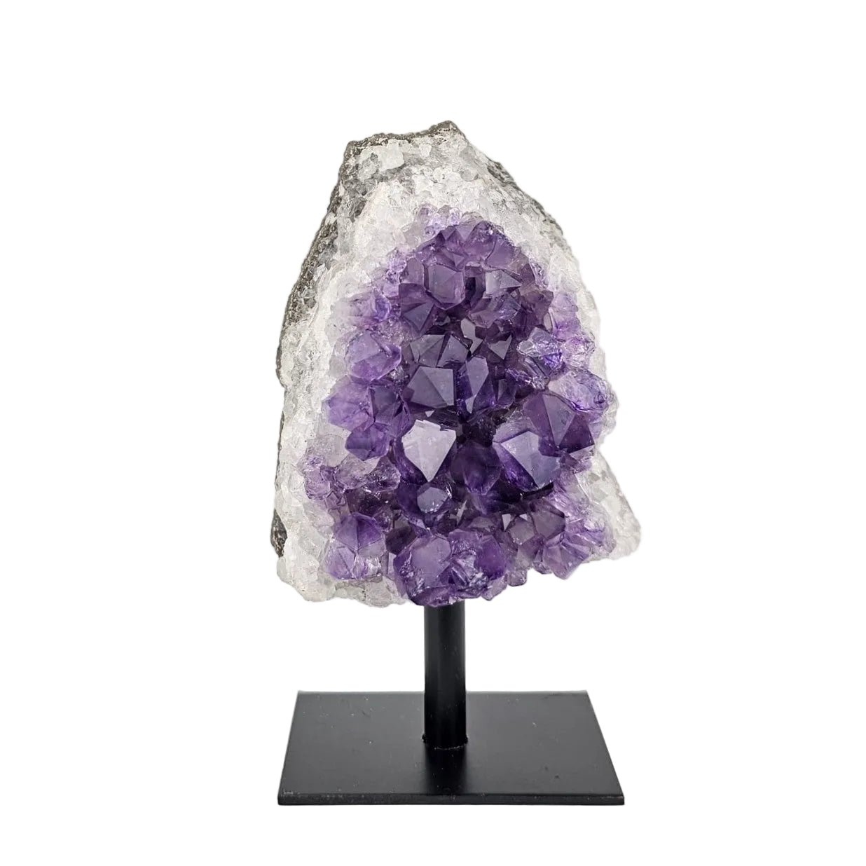 Amethyst cluster on stand on a white background