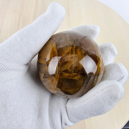 Dark golden healer sphere in white glove