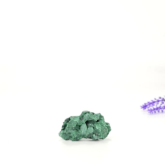 Raw fibrous malachite on a white background