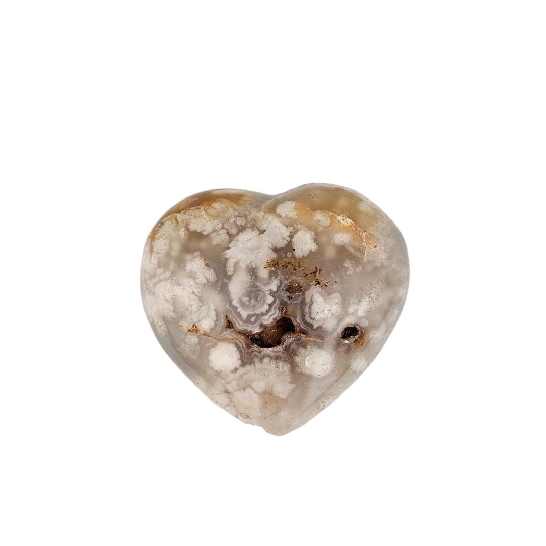 Heart-shaped agate stone with a rough texture on a white background