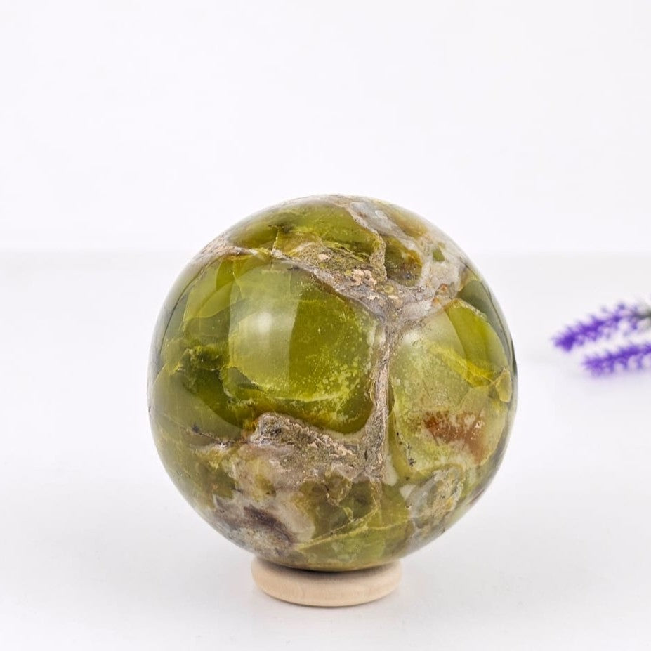 Green opal sphere on a white background