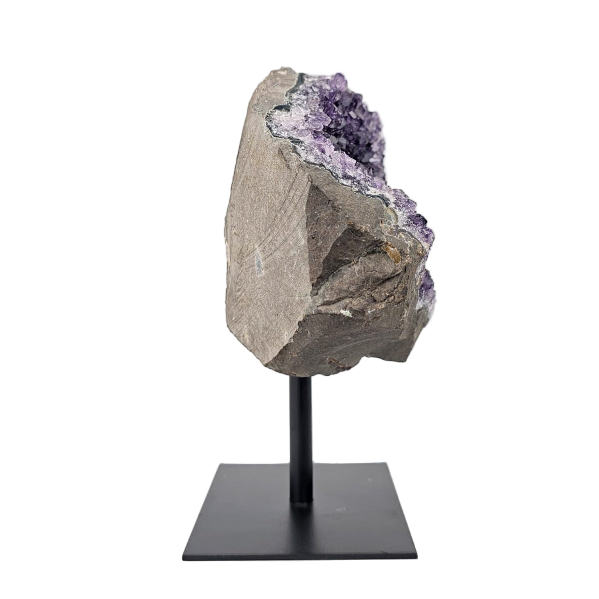 Amethyst crystal on a stand against a white background