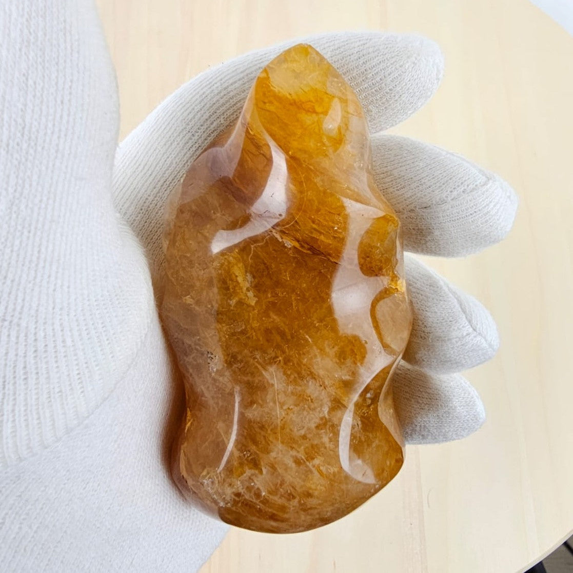 Golden healer sculpture in gloved hand