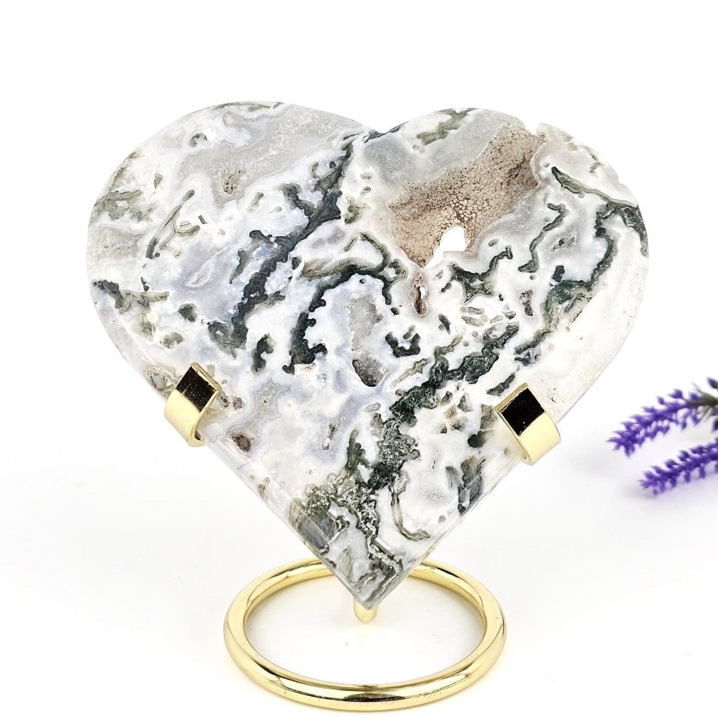 Heart-shaped moss agate with gold accents on a white background