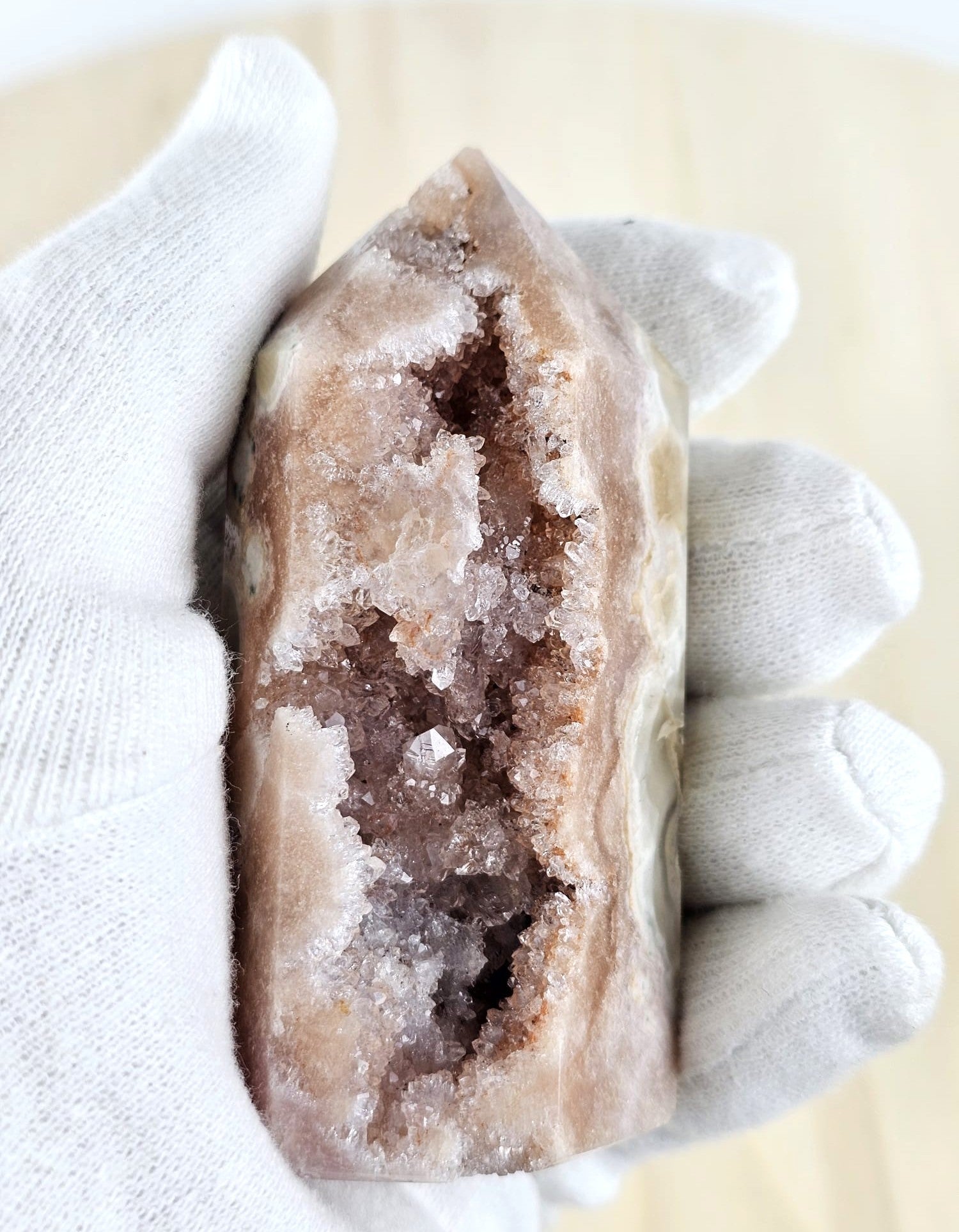 Pink amethist in hand with glove