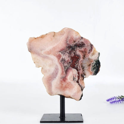 Pink amethyst brazil on a stand with a white background
