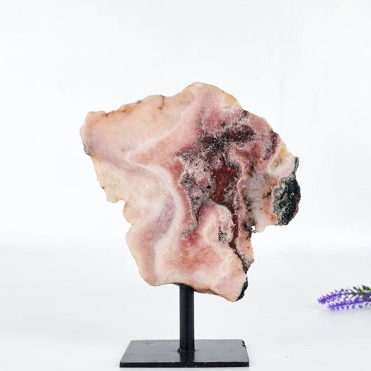 Pink amethyst brazil on a stand with a white background