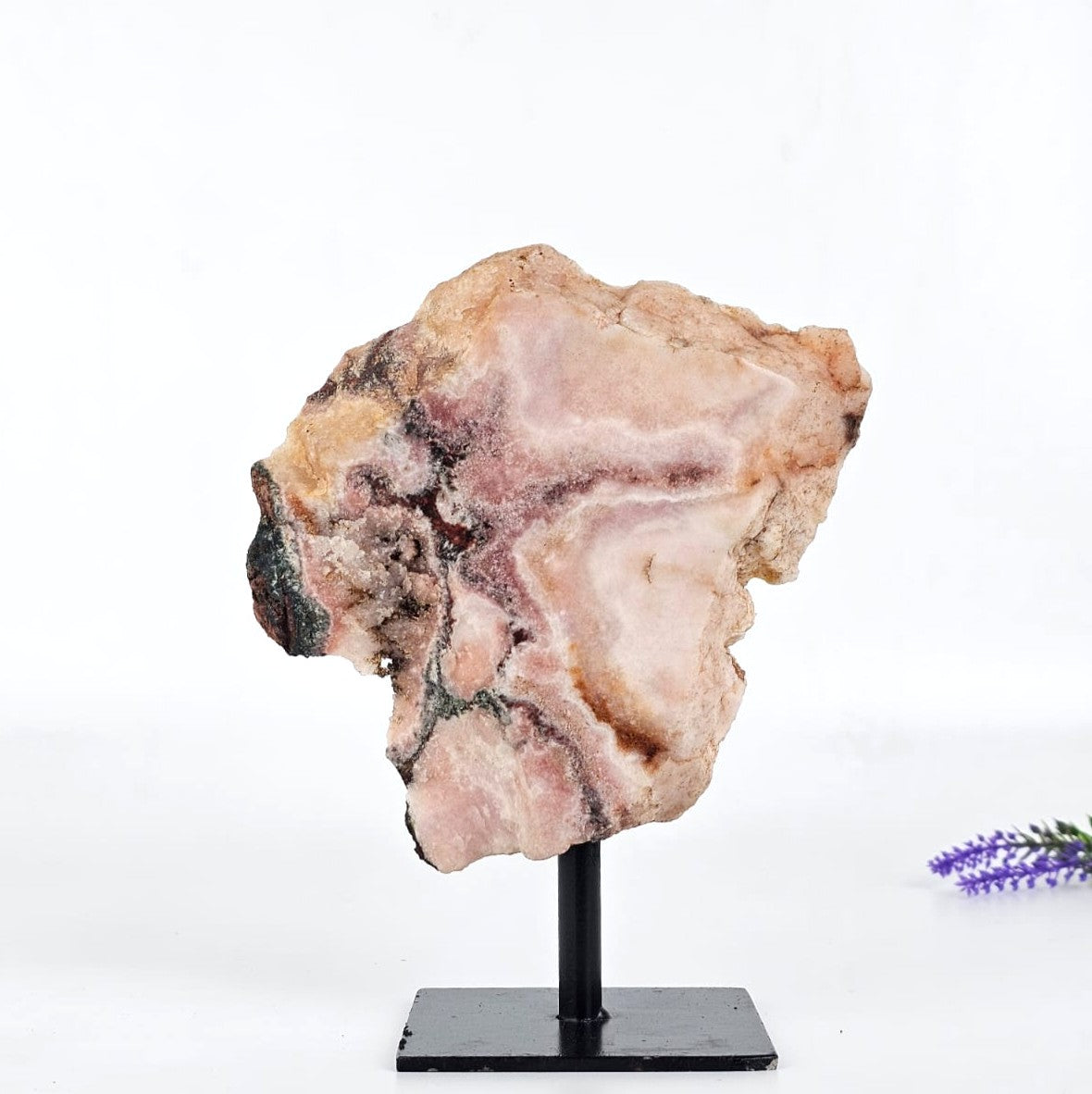 Pink amethyst back on a stand with a white background