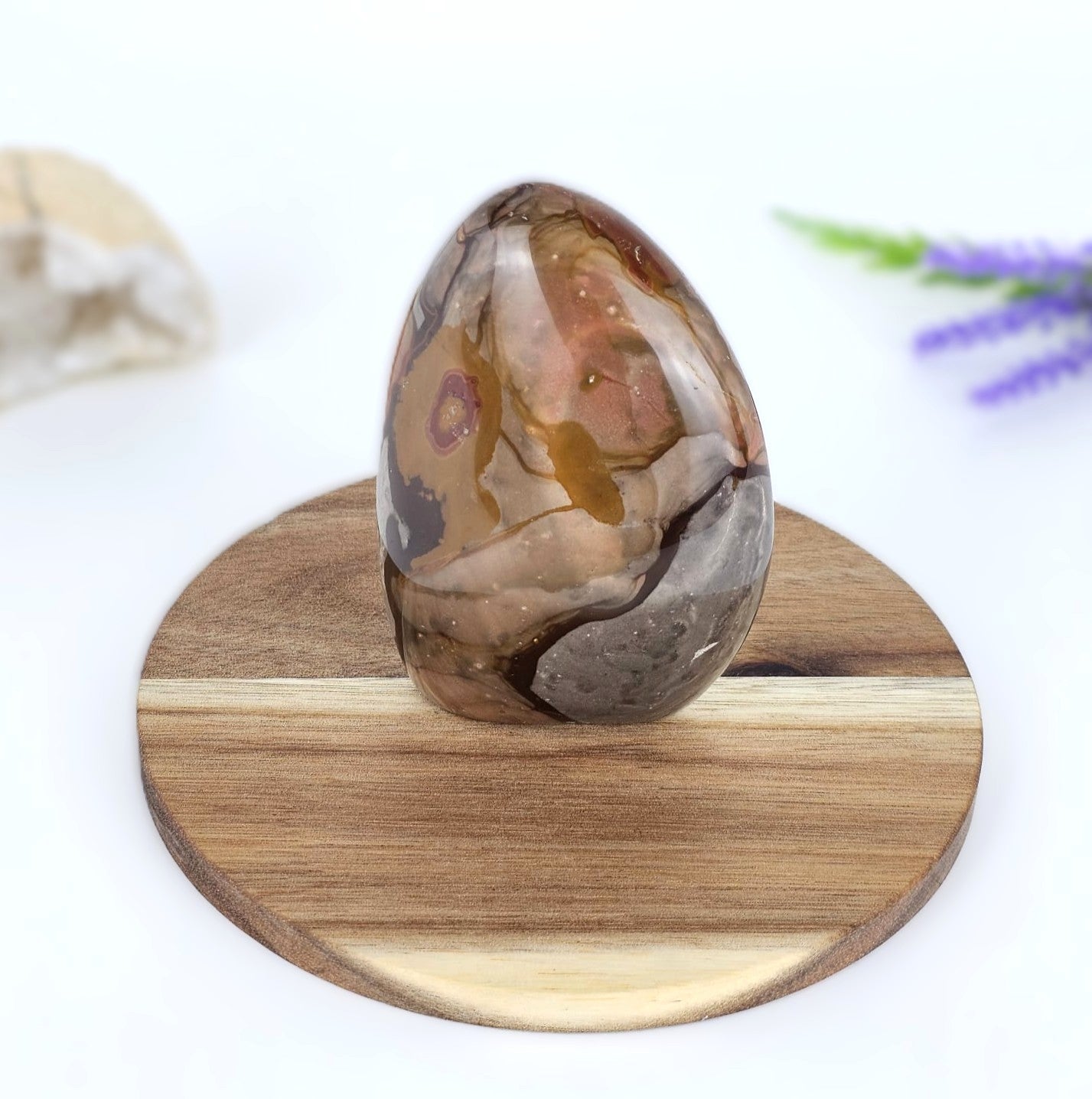 polychrome jasper on a wooden stand with a blurred background