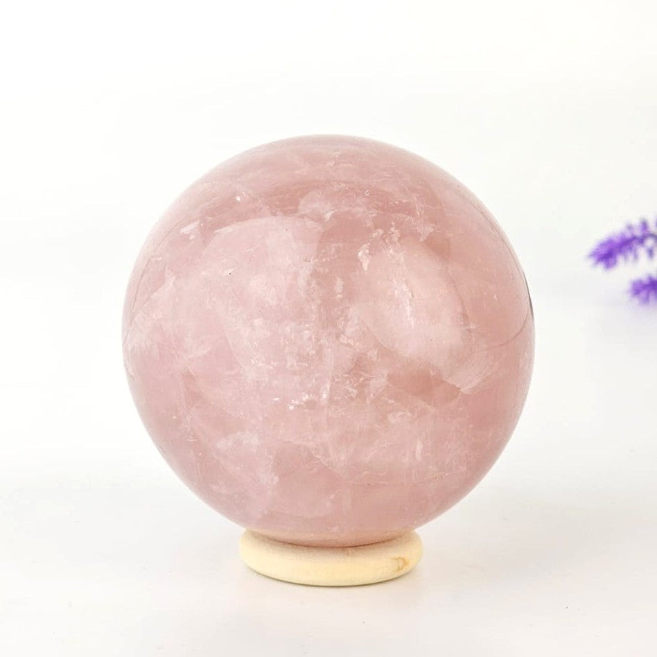 Rose quartz crystal sphere on a white background