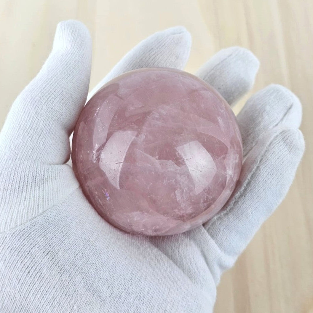 Rose quartz sphere in hand