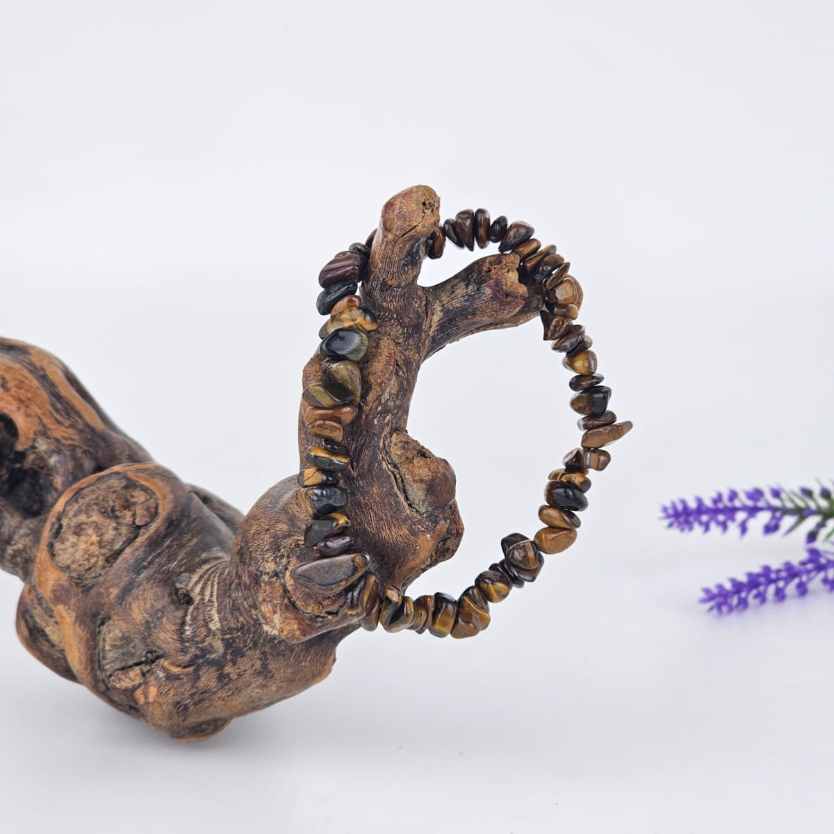 Tiger"s eye chip bracelet on a branch with a white background