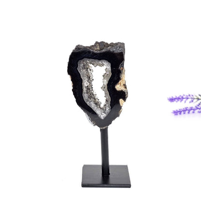 black agate druzy portal on a stand and a white background