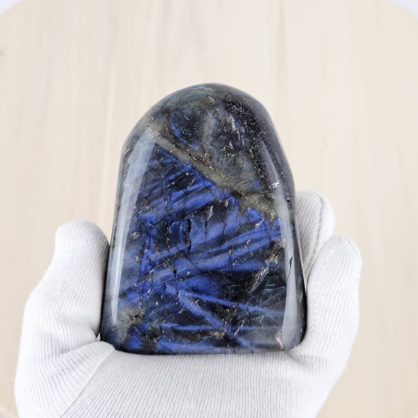 labradorite in gloved hand 