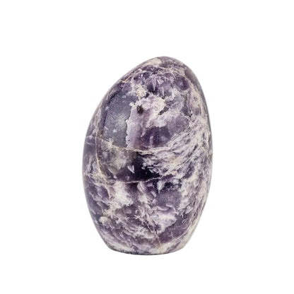 Purple and white lepidolite stone on a white background