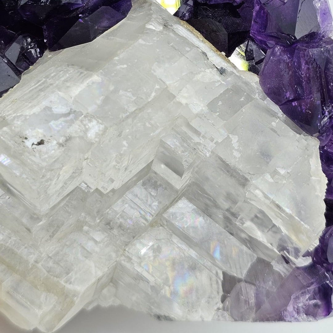 Close-up of a crystal formation with amethyst crystals in the background
