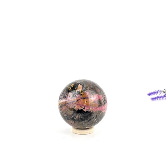 rhodonite crystal sphere on a white background