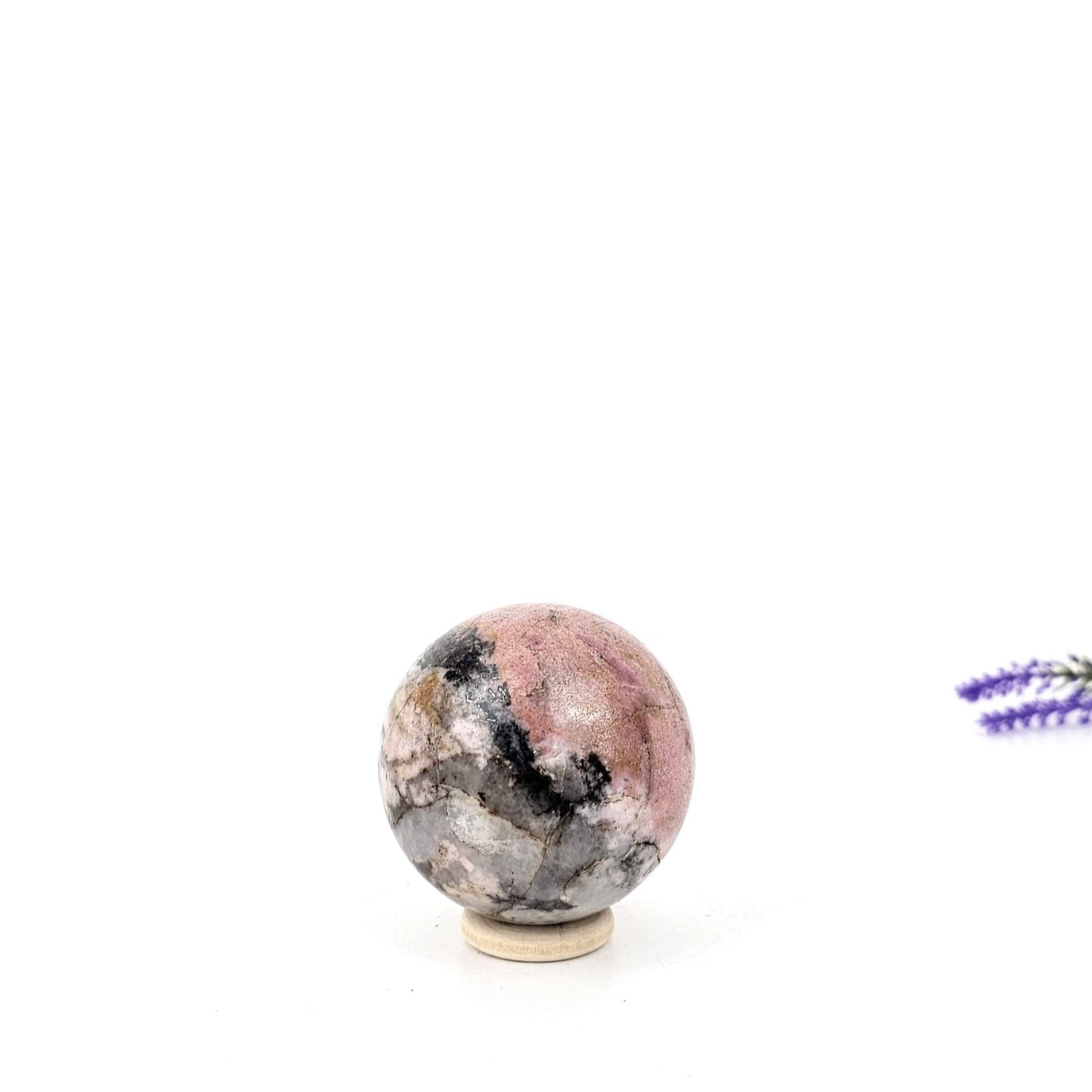 rhodonite crystal sphere on a white background