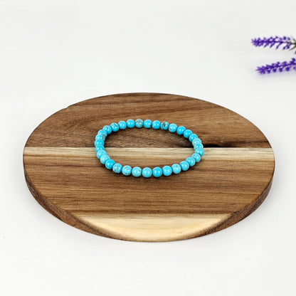 Beaded turquenite bracelet on a wooden platen and a white background